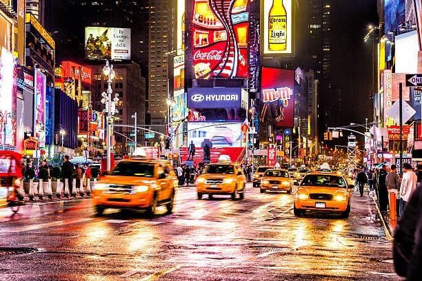 Nightlife in New York City: Times Square lights up at night, people enjoying vibrant nightlife